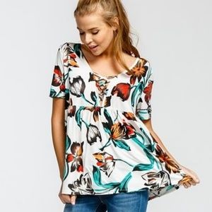 Peplum top with shirting and criss cross detail.